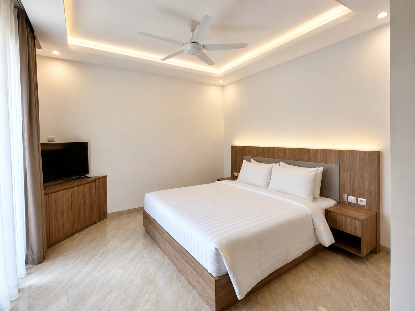 One-Bedroom Villa bedroom with warm lighting, wooden headboard and crisp white linens.